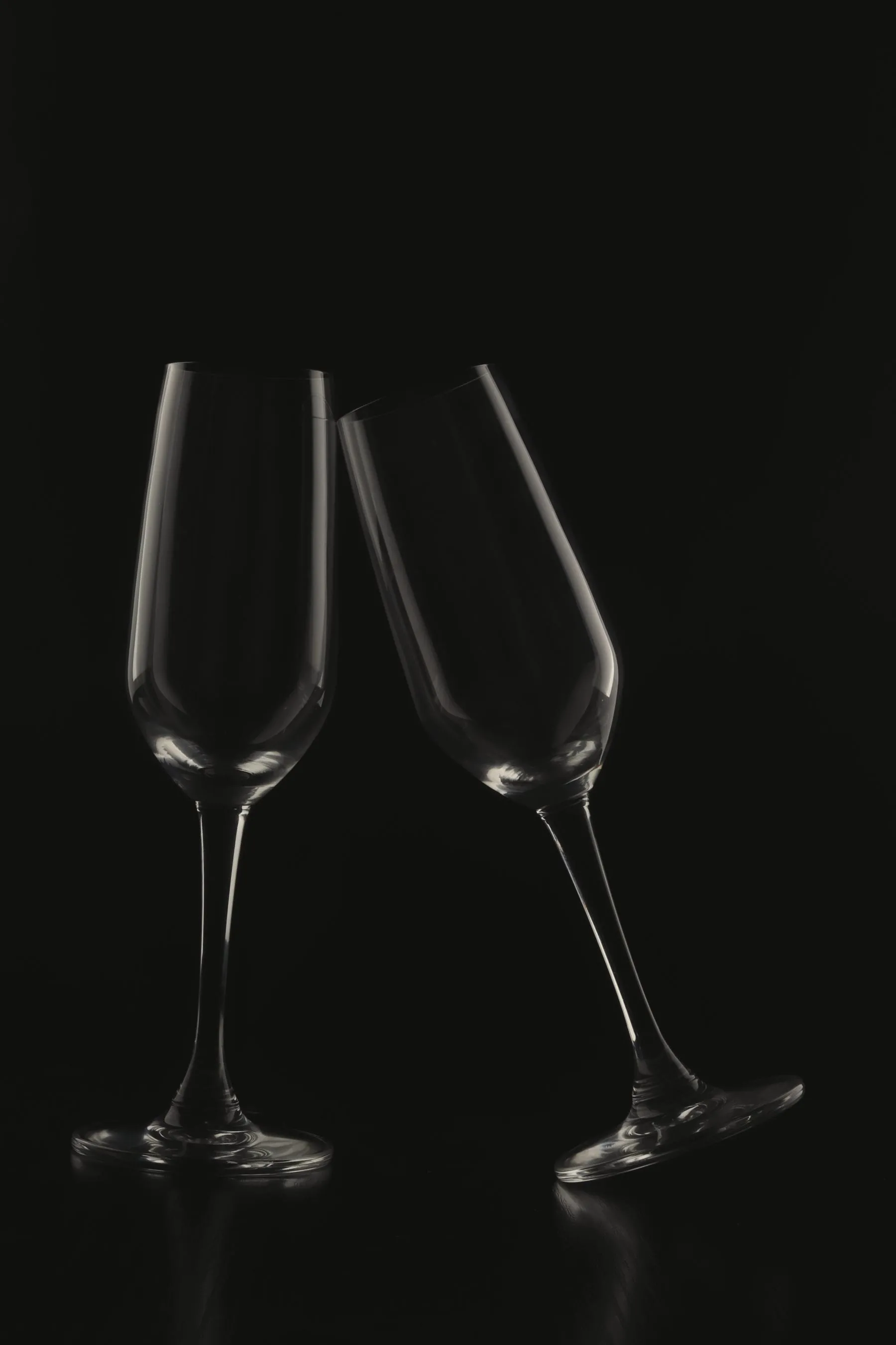 Two champagne flutes on a dark background